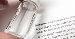 A morphine bottle over the medical journal for the substance