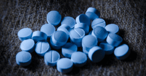 A pile of blue Benzodiazepines on a carpet