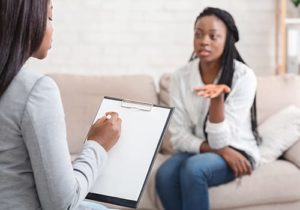 a patient talks with a therapist in a bipolar disorder treatment program