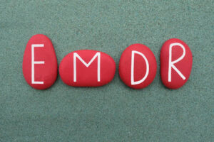 White letters in round, red background spelling out EMDR