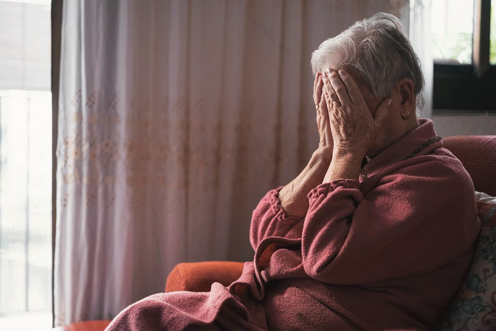 an older person puts their head in their hands as they go through substance abuse in older adults