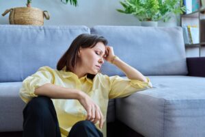 Woman lays on her couch and sighs while trying out an alternative to valium